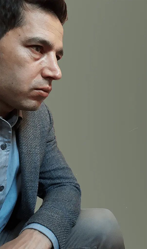 About: Portrait image of a person sitting on the right side