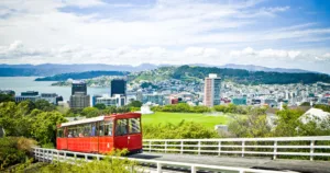 Red train, city view and blue sky of new zealand